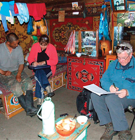 Dr. Clyde Goulden (foreground) interviews a Mongolian herder in his home. Credit: Lkhagva Ariuntsetseg